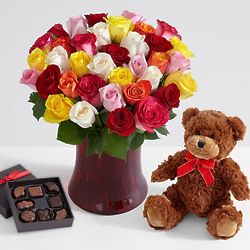 3 Dozen Rainbow Roses in Ruby Vase with Chocolates & Bear